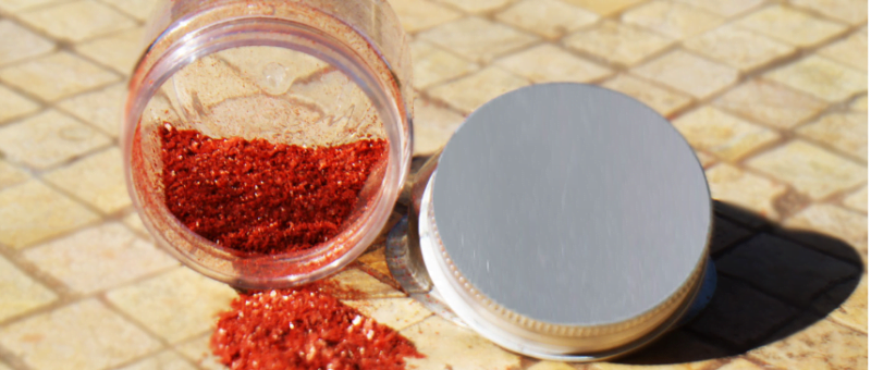 Aker El Fassi powder, a vibrant red spice commonly used in Moroccan cuisine, showcasing its rich color and texture.